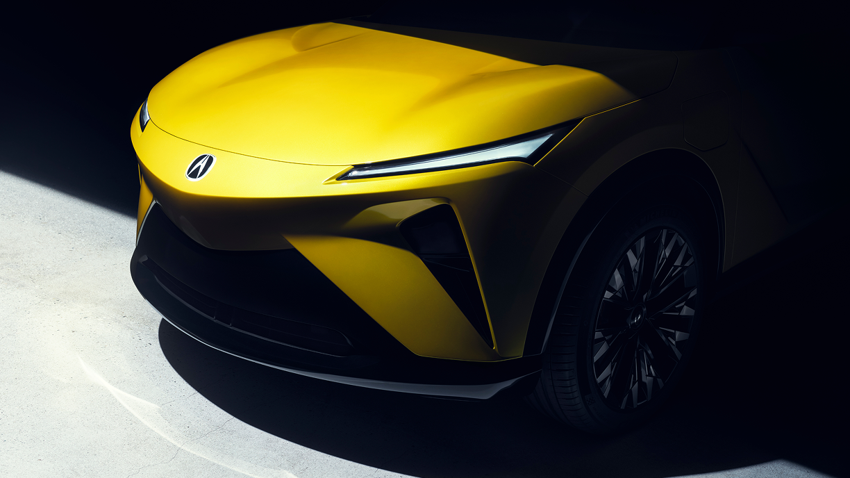 Close-up of the front of a gold RSX prototype in a black shadowed background.  