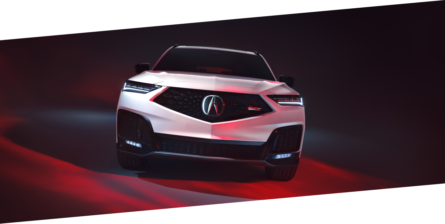 Plan avant d’un MDX Type S Ultra blanc dans un studio éclairé par une lumière rouge.