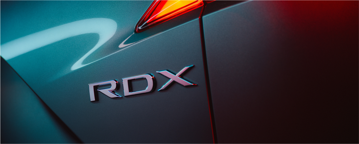Gros plan sur les badges RDX et SH-AWD sur le RDX gris.