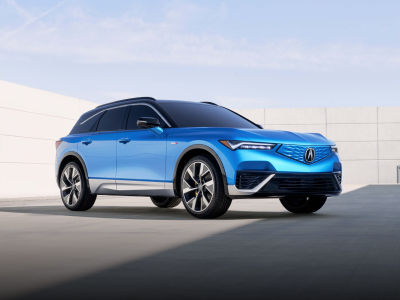 3/4 front view of blue ZDX parked, surrounded by modern, minimalistic architecture.